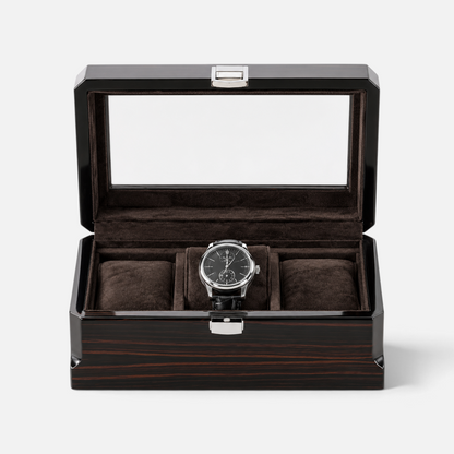 Clairly Sable 3-slot watch box in ebony wood with a glass lid and dark brown linen interior holding a luxury watch.