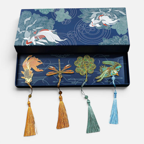 Clairly set of four enamel bookmarks featuring koi, dragonfly, clover, and phoenix designs with tassels in a gift box.