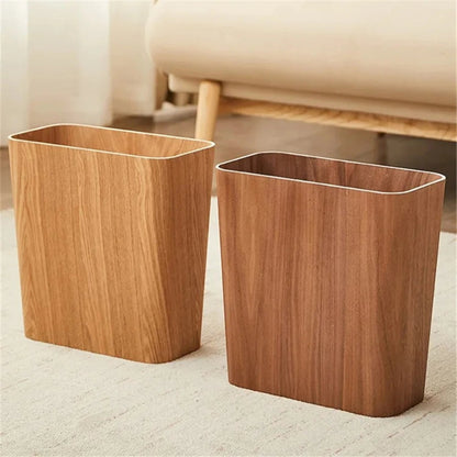 Clairly Japanese style rectangular wooden trash cans in natural oak and walnut finishes on a carpeted floor.