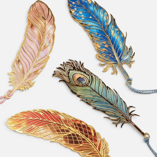 Clairly iridescent peacock feather bookmarks with gold-edged laser-cut designs and delicate tassels on a textured base.