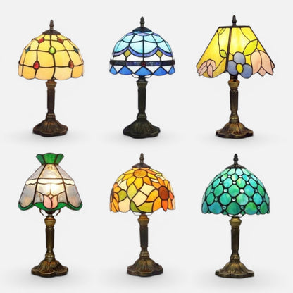 Clairly vintage mosaic stained glass table lamps with antique bronze bases in various floral and geometric patterns.