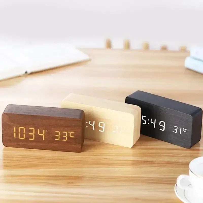 Clairly wooden LED digital alarm clocks in dark wood, light wood, and black finishes displaying time and temperature.