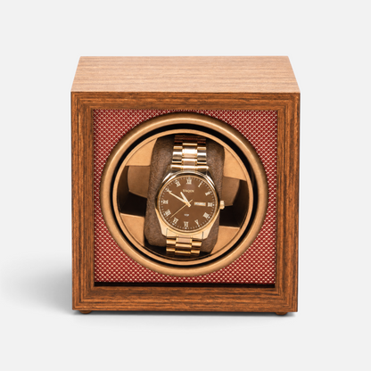 Clairly Heritage 1-slot watch winder in solid wood with a gold watch inside, featuring a glass lid and quiet motor.