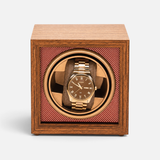 Clairly Heritage 1-slot watch winder in solid wood with a gold watch inside, featuring a glass lid and quiet motor.